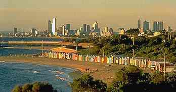 Brighton Beach boathouses with a view of the Melbourne Skyline
